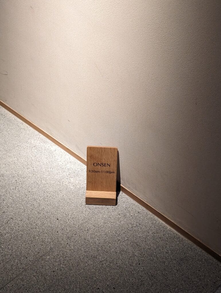 a wooden block on the corner of a wall