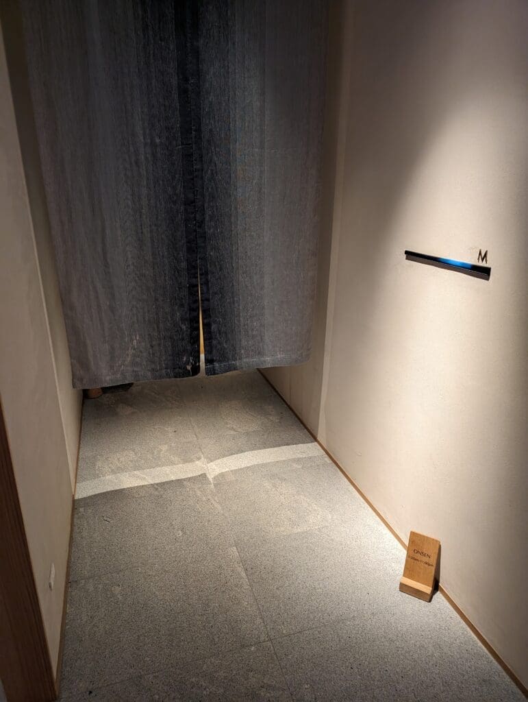 a hallway with a light on the wall