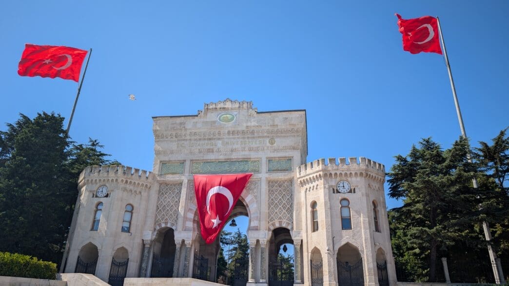 a large stone building with a flag from the front
