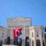 a large stone building with a flag from the front