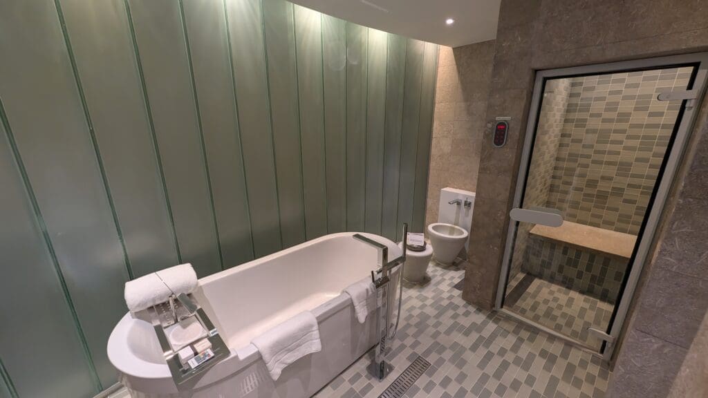 a bathroom with a tub toilet and toilet