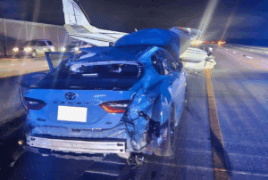 a car with a crashed plane on the back