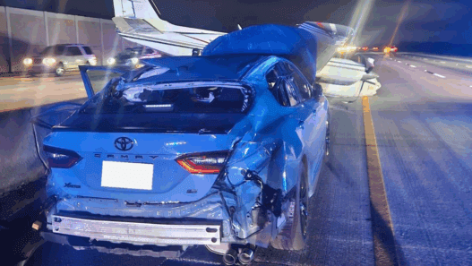 a car with a crashed plane on the back