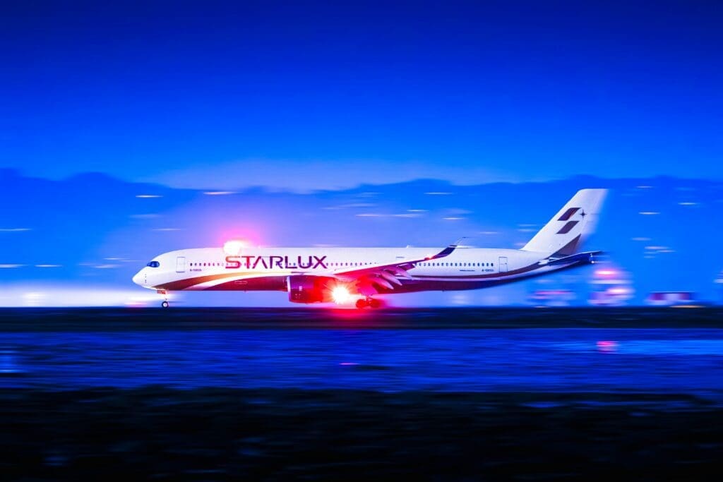 a white airplane taking off at night