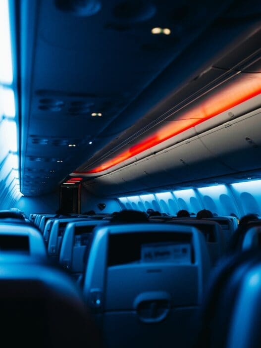 inside an airplane with seats and lights