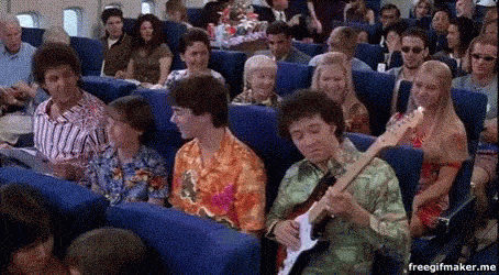 a group of people sitting in a room playing a guitar