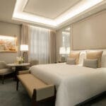 a bedroom with a bed and chairs