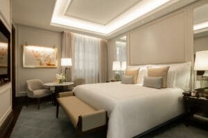 a bedroom with a bed and chairs