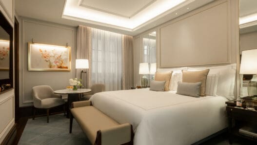 a bedroom with a bed and chairs