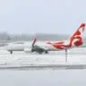 a white and red airplane on a snowy runway