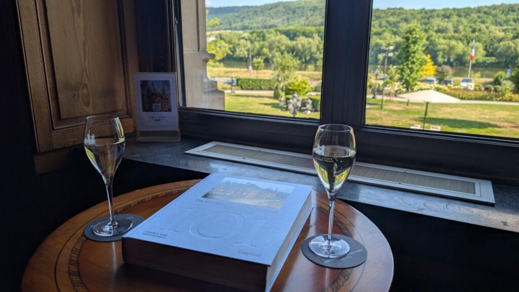 a book and wine glass on a table