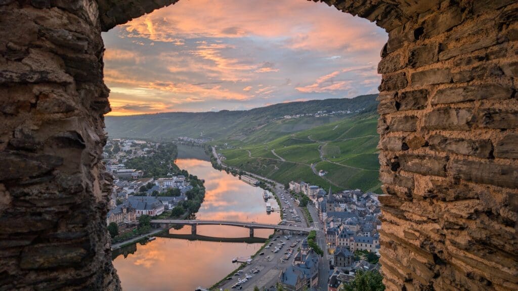 a view of a river and a city from a stone wall