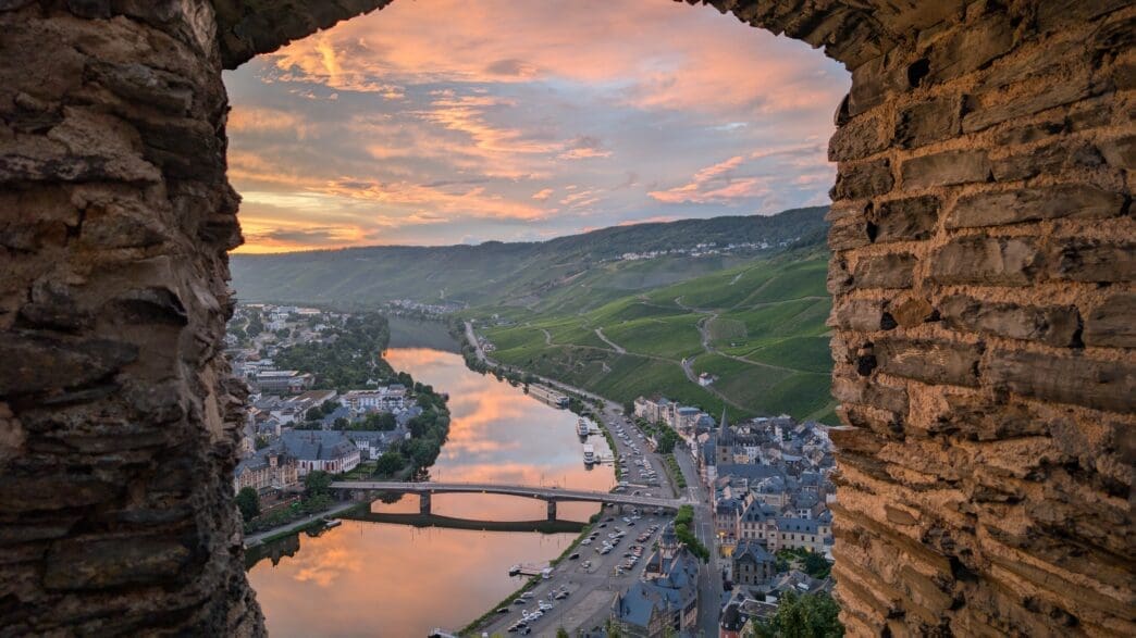 a view of a river and a city from a stone wall