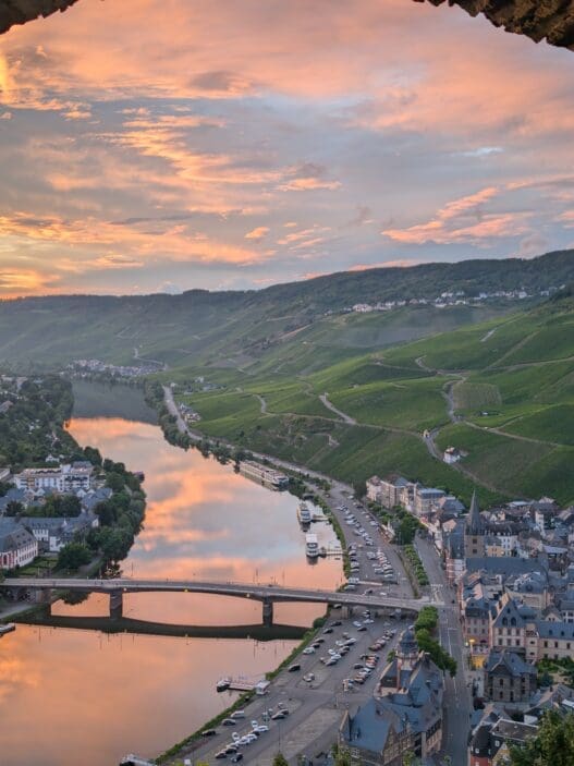 a view of a river and a city from a stone wall