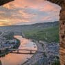 a view of a river and a city from a stone wall
