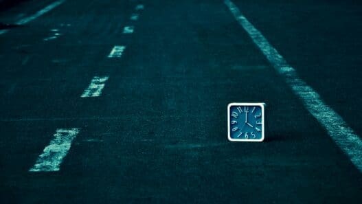 a square clock on the road