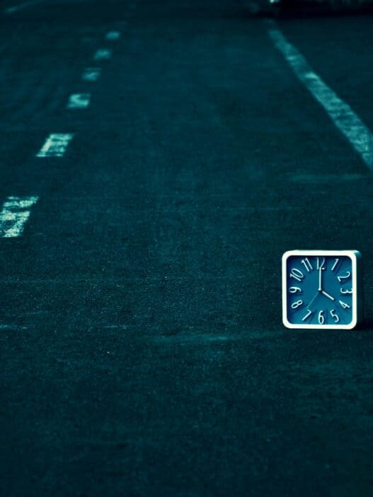 a square clock on the road