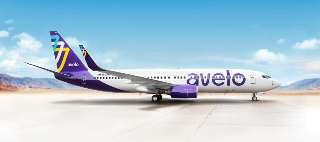a white and purple airplane on a runway