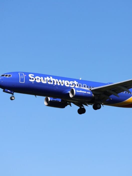 a blue airplane in the sky