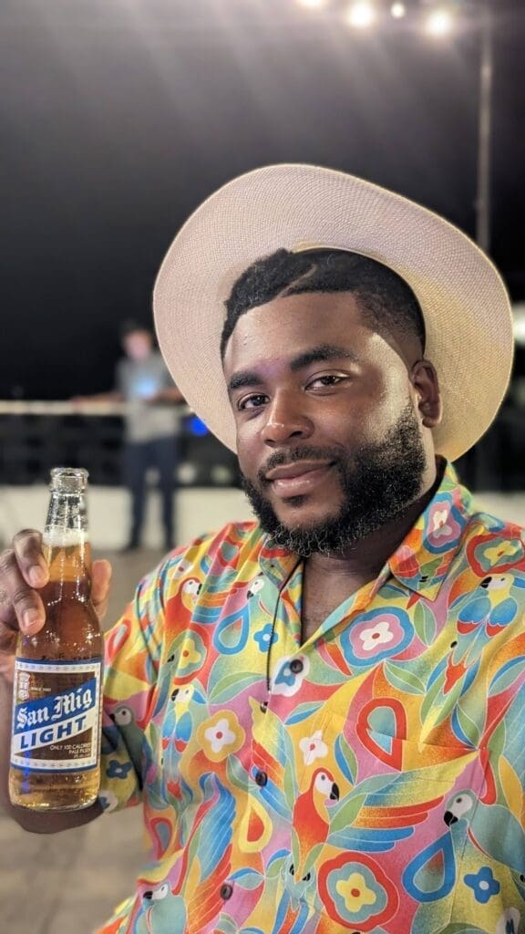 a man holding a bottle of beer