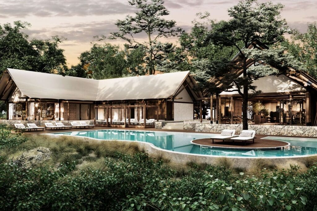 a swimming pool with lounge chairs and trees around it