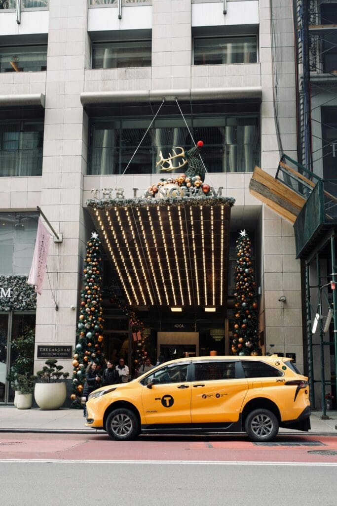 a yellow car in front of a building