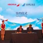 a group of people on a stage signing papers