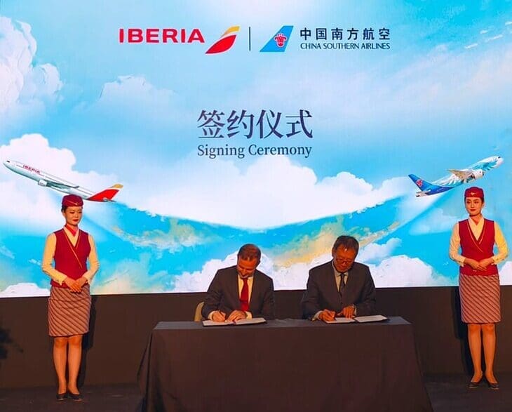 a group of people on a stage signing papers