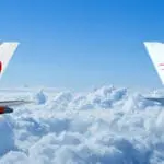 two planes flying above the clouds