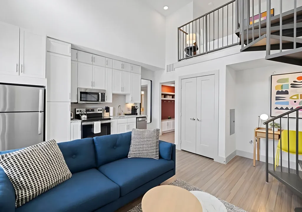 a living room with a blue couch and a loft