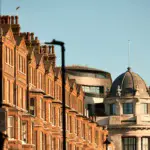a row of brick buildings with a dome top
