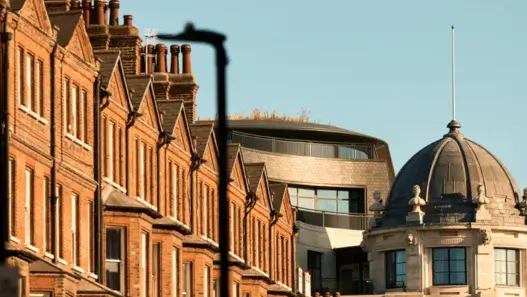 a row of brick buildings with a dome top