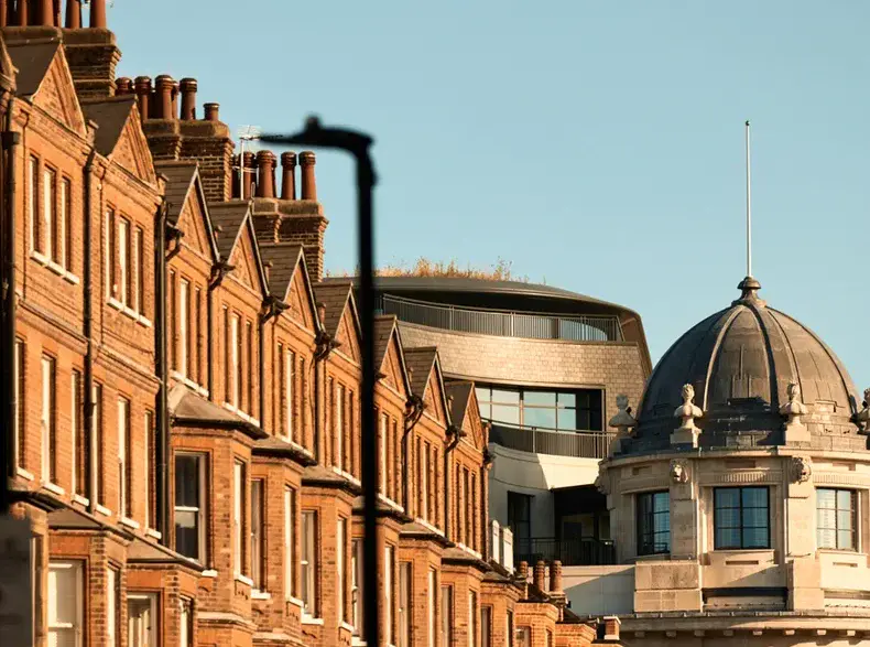 a row of brick buildings with a dome top