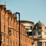 a row of brick buildings with a dome top