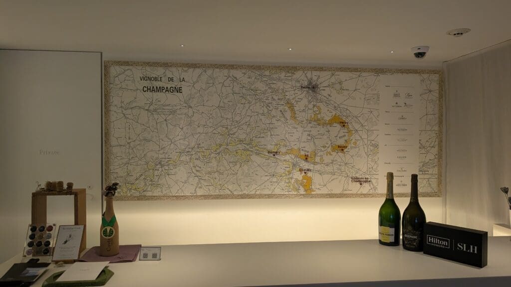 a map of champagne and two bottles on a white table