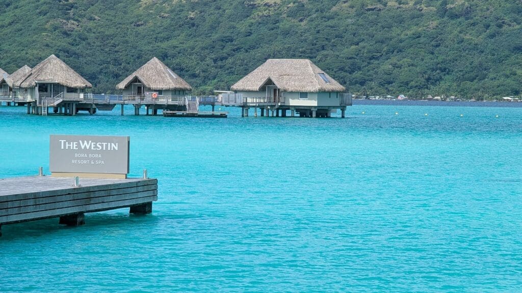 a group of houses on stilts in the water