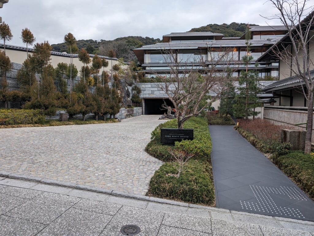 a building with a driveway and trees