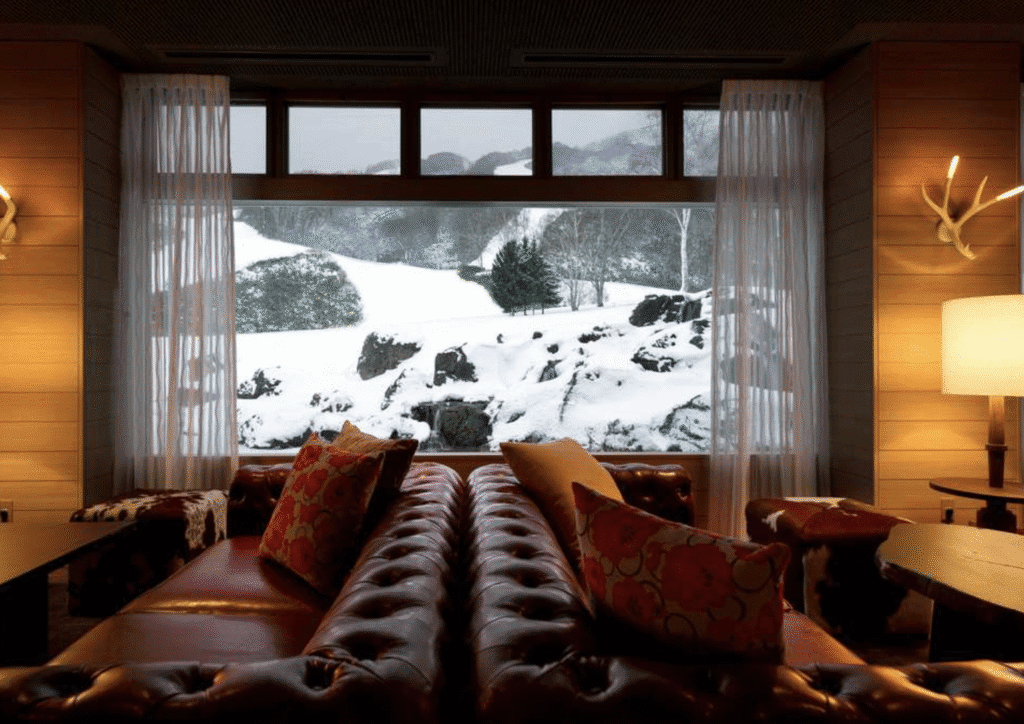 a room with a couch and a view of snow