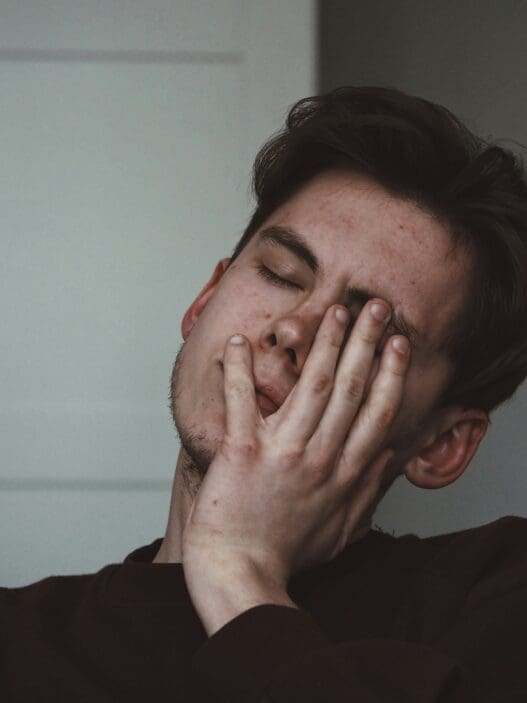 a man with his hand on his face