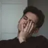 a man with his hand on his face