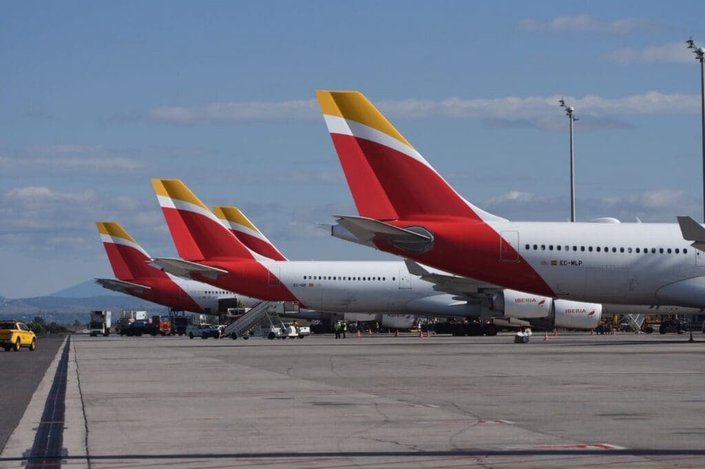 a row of airplanes parked on a runway