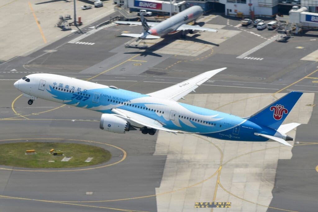 an airplane flying over a runway