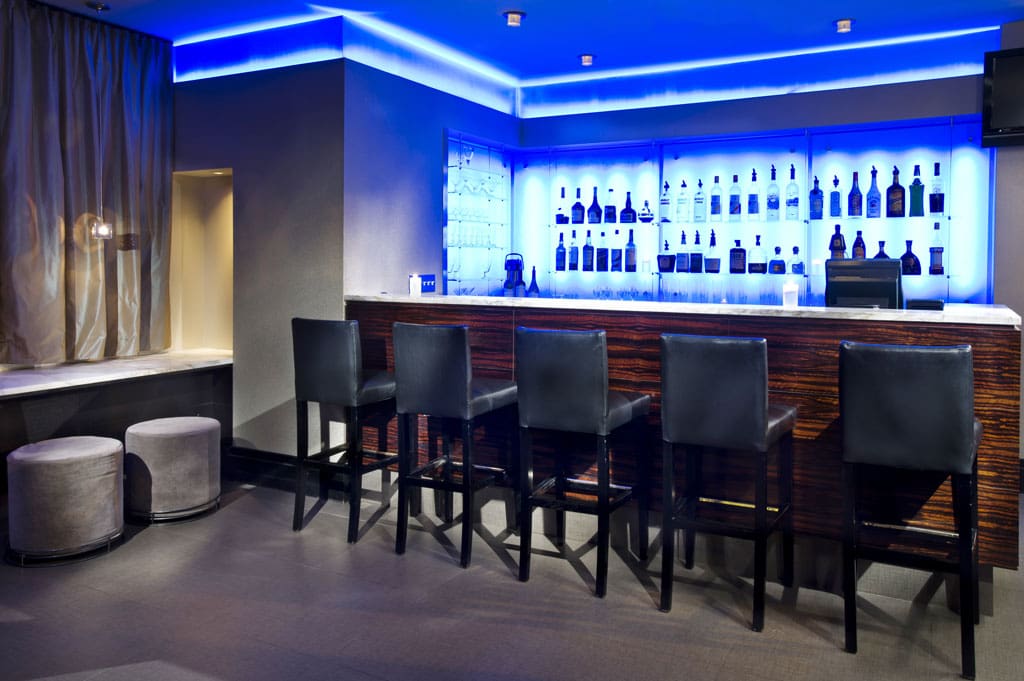 a bar with a row of chairs and a stool