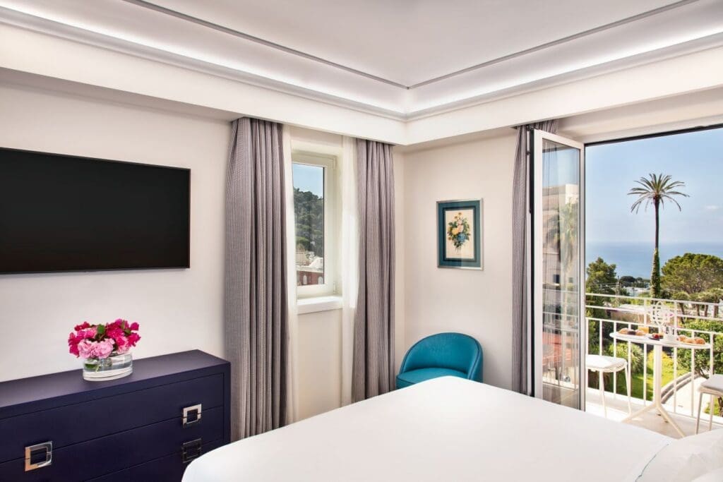 a room with a bed and a dresser and a tv