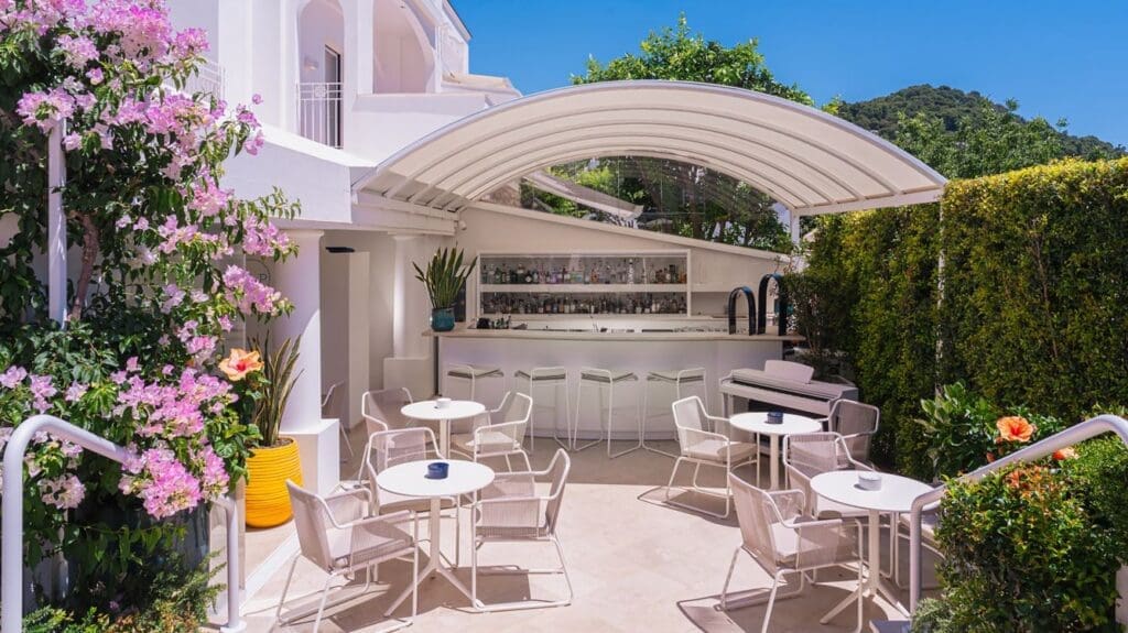 a white patio with tables and chairs