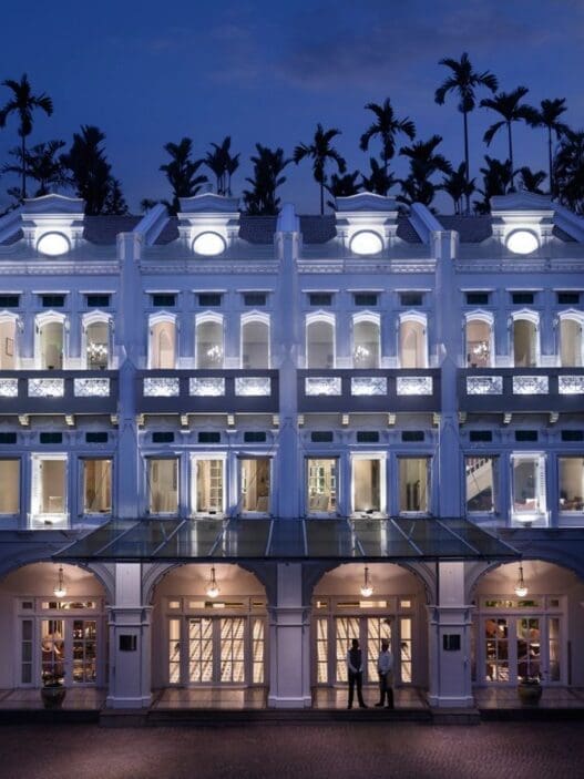 a building with many windows and a couple of people standing in front of it