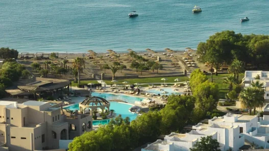 a swimming pool and a beach with a body of water