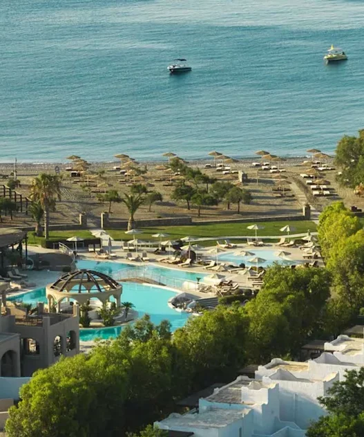 a swimming pool and a beach with a body of water