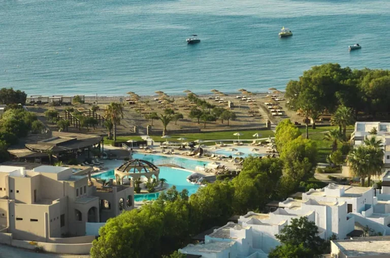 a swimming pool and a beach with a body of water