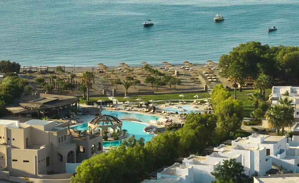 a swimming pool and a beach with a body of water